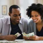 Couple counting money --- Image by © Jose Luis Pelaez Inc/Blend Image/Blend Images/Corbis